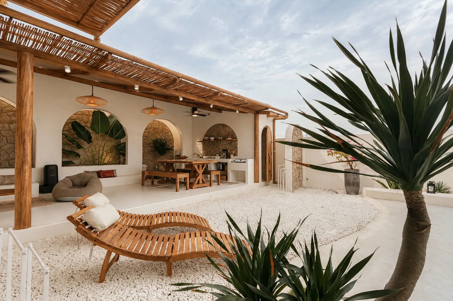 Casa Tanaw open-air lounge with woven furniture, timber canopy, and sculptural tropical plants